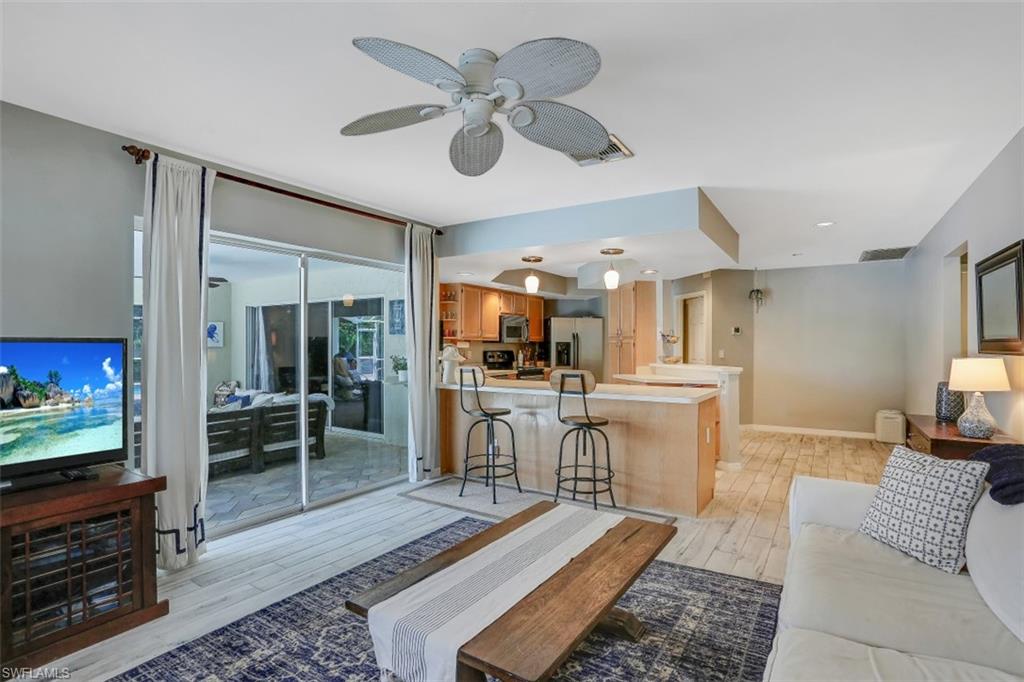 7359 Stonegate Drive Naples, FL 34109 - Photo 7 of 33 a living room with furniture and a flat screen tv