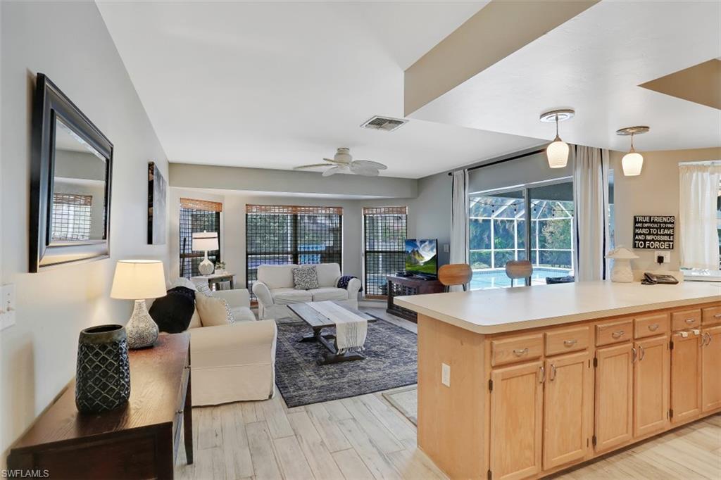7359 Stonegate Drive Naples, FL 34109 - Photo 8 of 33 a view of kitchen island a sink and living room
