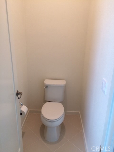 1613 East Lincoln Avenue Anaheim, CA 92805 - Photo 15 of 26 a white toilet sitting in a bathroom