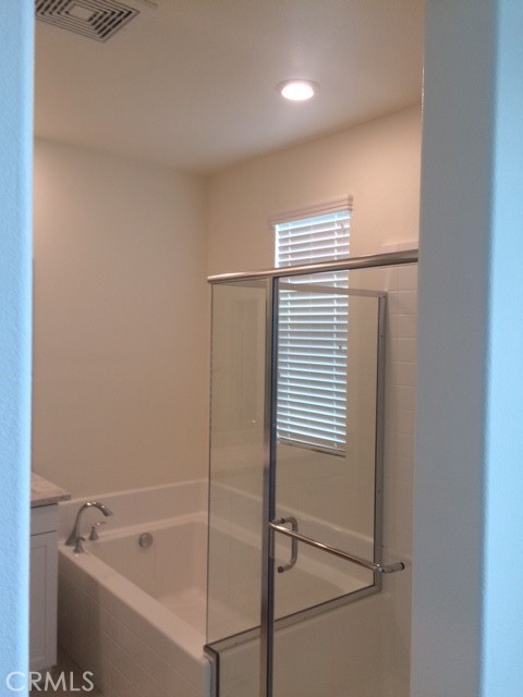 1613 East Lincoln Avenue Anaheim, CA 92805 - Photo 16 of 26 a bathroom with a bathtub and a shower