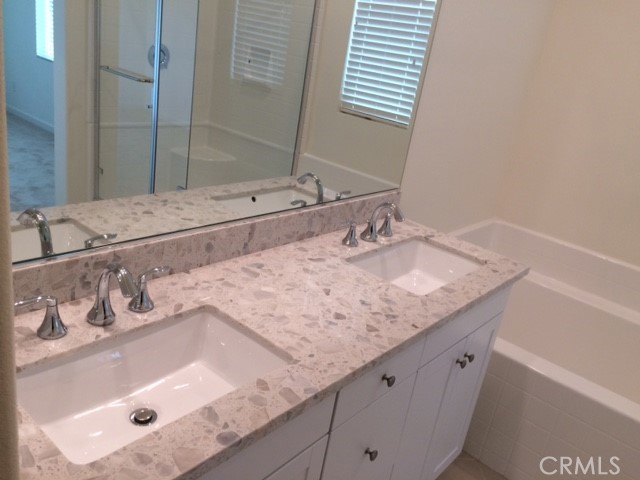 1613 East Lincoln Avenue Anaheim, CA 92805 - Photo 17 of 26 a bathroom with a granite countertop sink and a mirror