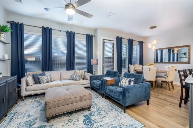 a living room with furniture and a large window