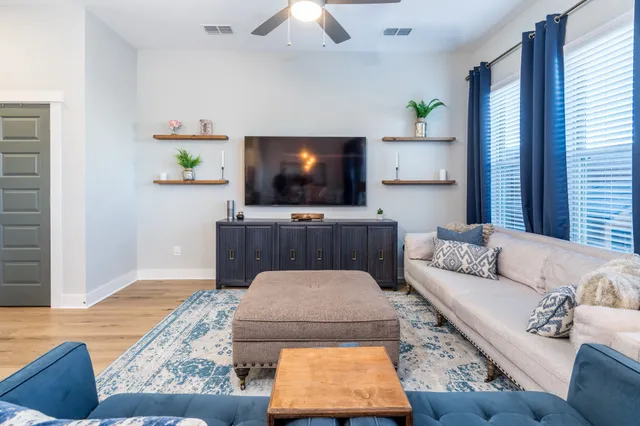 a living room with furniture and a flat screen tv