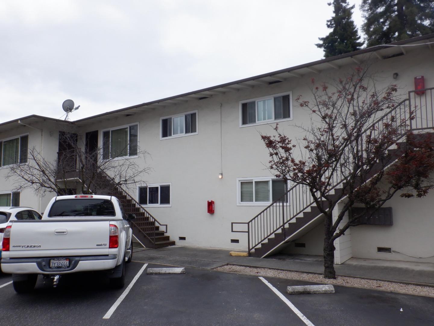 520 Chestnut Street Santa Cruz, CA 95060 - Photo 3 of 14 a view of a white house with a large space and a car parked in front of it