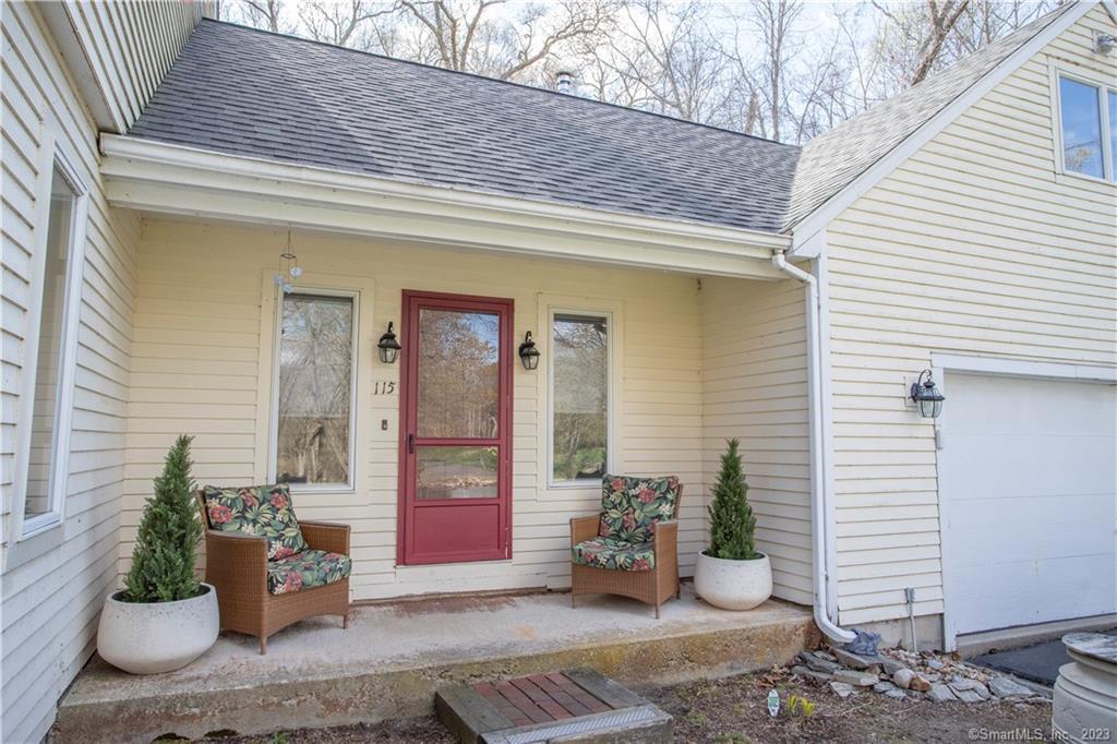 a view of a patio with dining table and chairs and potted plants