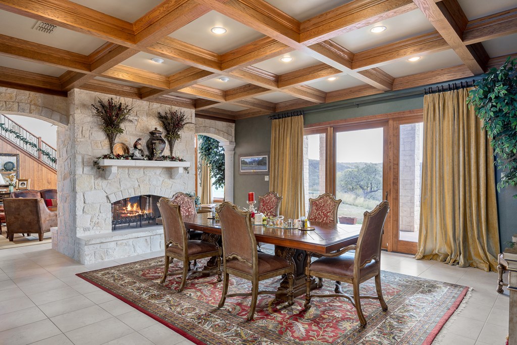 945 Elm Pass Road Center Point, TX 78010 - Photo 17 of 37 Dining Room with coffered ceiling., Fireplace can be seen from Dining Room and Living Room.
