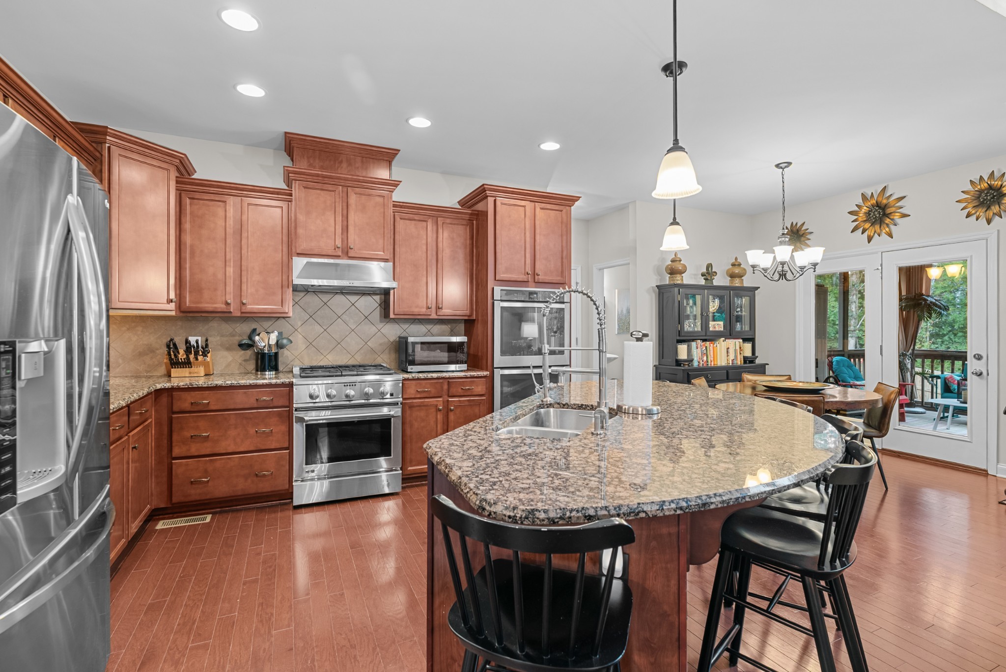 413 Marlowe Court Nolensville, TN 37135 - Photo 11 of 37 a kitchen with kitchen island a stove a table and chairs in it