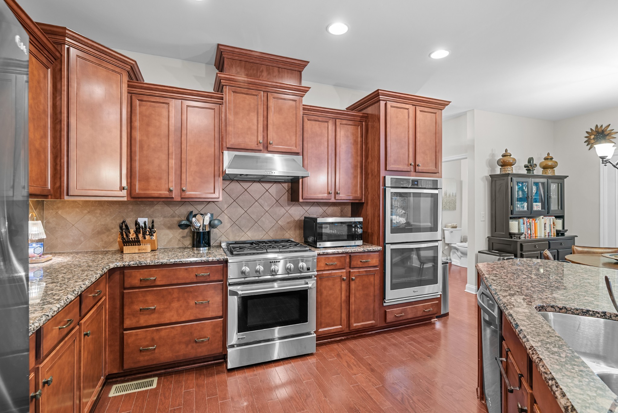 413 Marlowe Court Nolensville, TN 37135 - Photo 13 of 37 a kitchen with stainless steel appliances granite countertop a stove a sink and a refrigerator