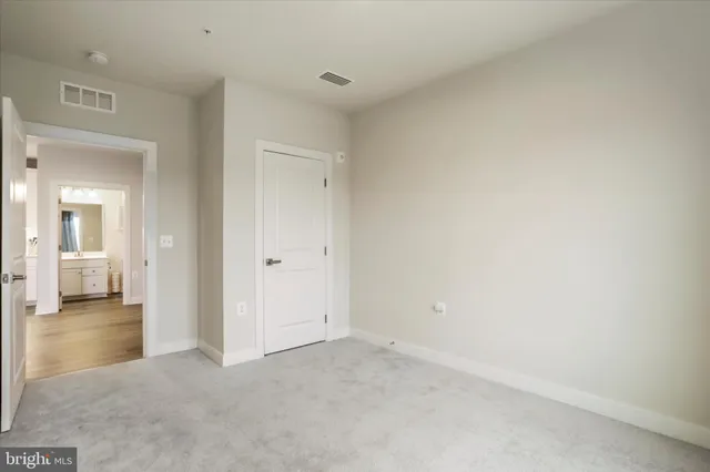 a view of a room with an empty space and wooden floor