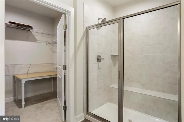a bathroom with a glass shower door