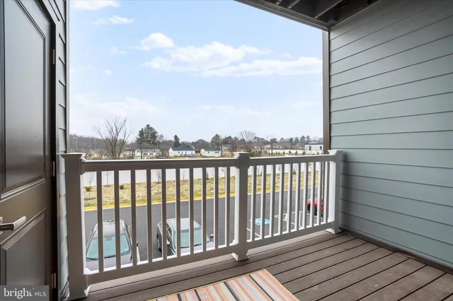 a view of a balcony with wooden floor