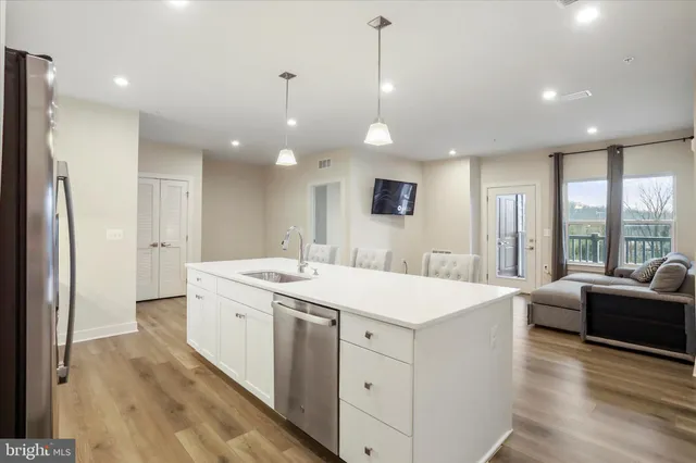 a large white kitchen with a large window