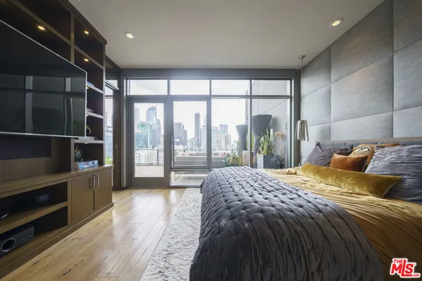 a bed sitting in a bedroom next to a large window