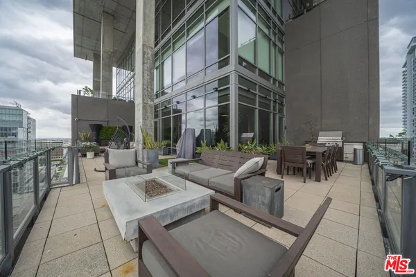 a view of a patio with couches table and chairs and potted plants