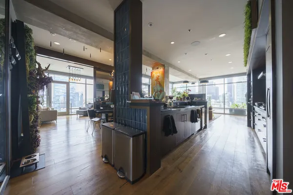 a large open kitchen with a large window a sink and stainless steel appliances