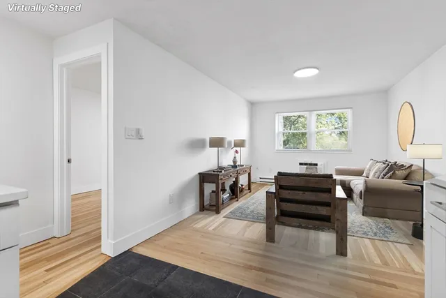 a living room with furniture and a piano