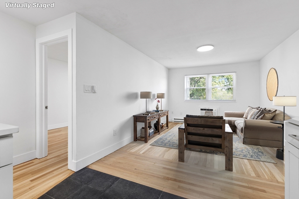 303 Broadway, Unit C2 Lynn, MA 01904 - Photo 2 of 15 a living room with furniture and a piano