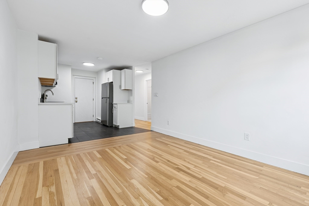 303 Broadway, Unit C2 Lynn, MA 01904 - Photo 7 of 15 a view of empty room with wooden floor