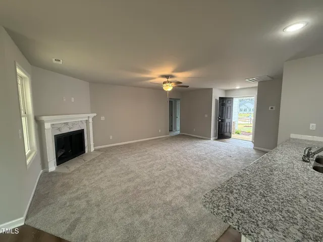 a view of an empty room with a fireplace