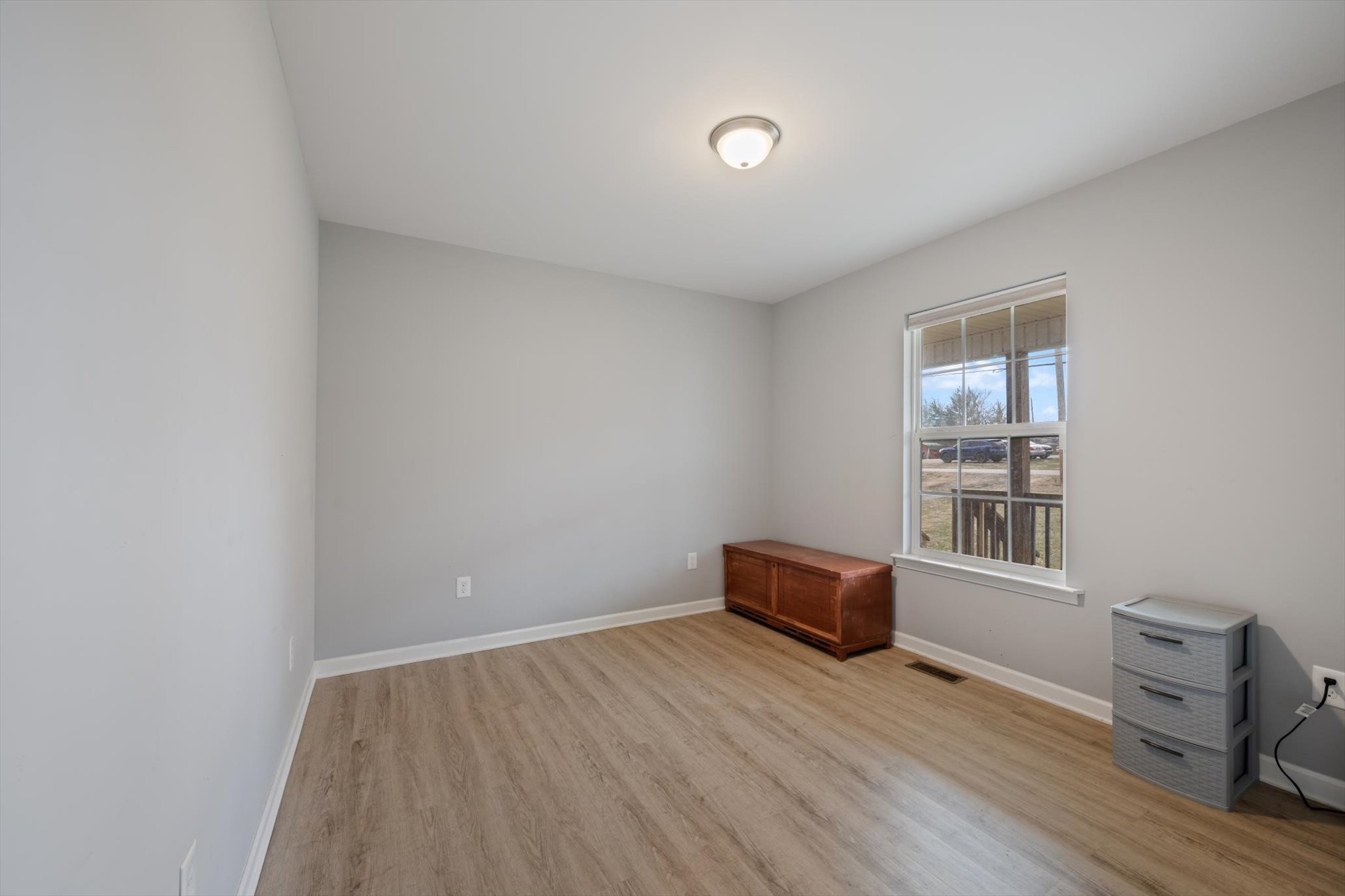 426 Edgewood Street Alexandria, TN 37012 - Photo 16 of 17 an empty room with wooden floor and windows