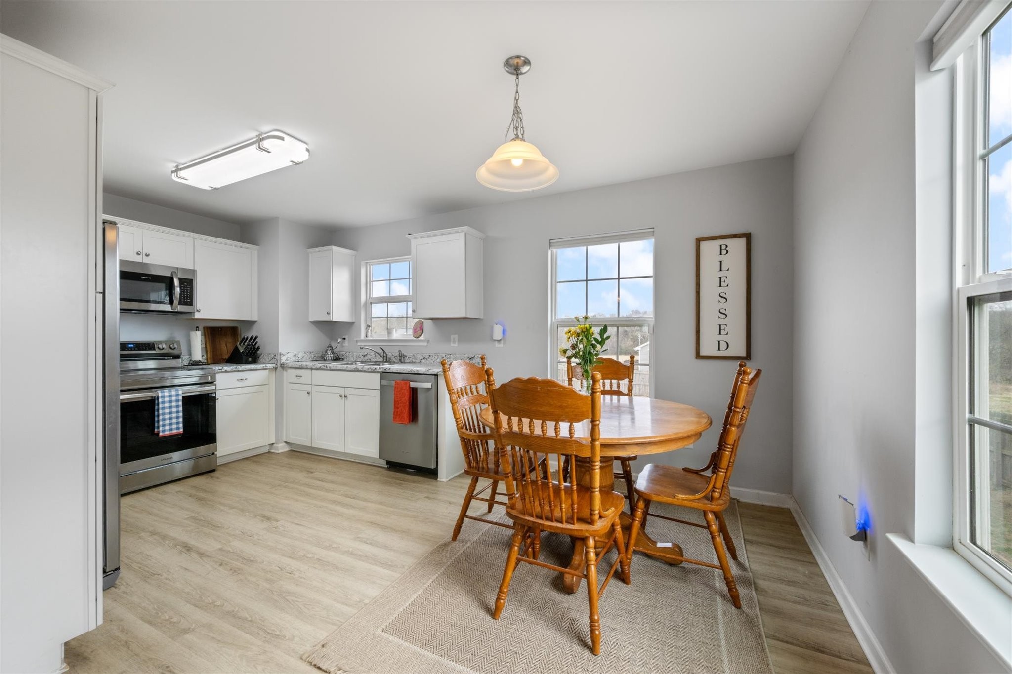426 Edgewood Street Alexandria, TN 37012 - Photo 7 of 17 a kitchen with a dining table chairs and refrigerator