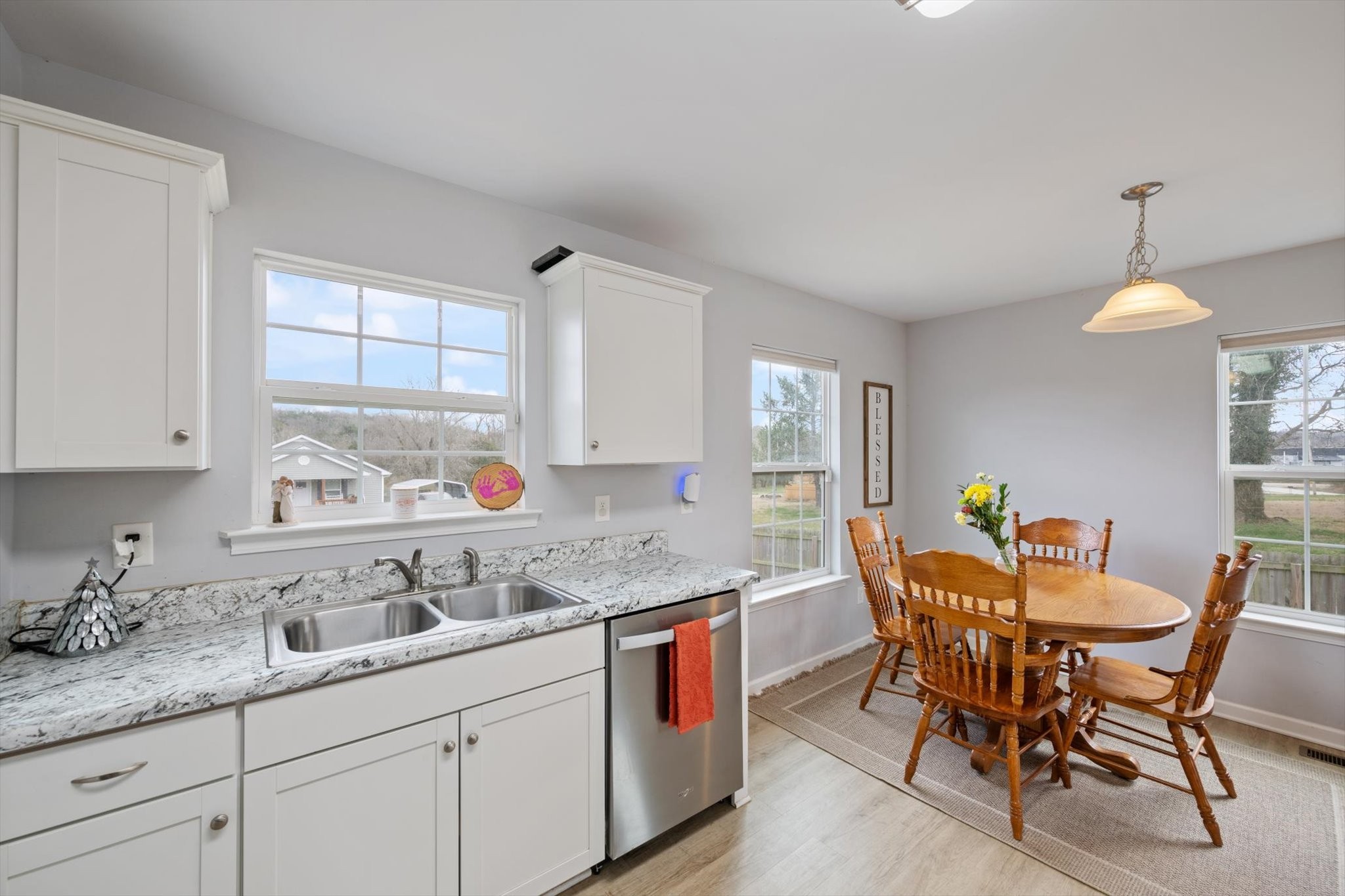 426 Edgewood Street Alexandria, TN 37012 - Photo 8 of 17 a kitchen with a dining table chairs and white cabinets