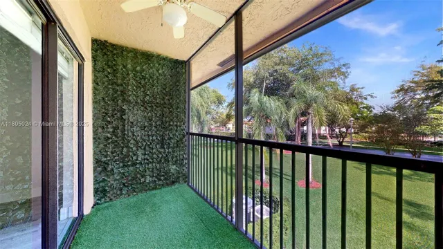 a view of a porch and a yard from a balcony