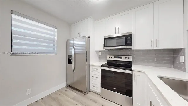 a kitchen with stainless steel appliances granite countertop a sink and stove top oven