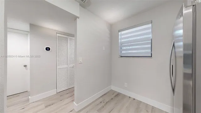 a bedroom with bed and a potted plant