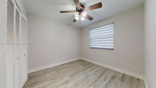 a bathroom with a bathtub shower sink vanity mirror and toilet