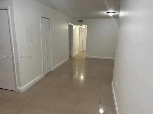 a view of an empty room with a bathroom