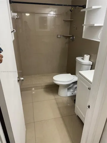 a bathroom with a toilet and a shower