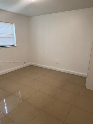 an empty room with a bench