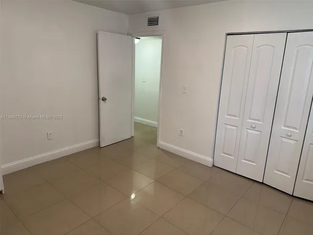 a view of a closet area with hardwood floor
