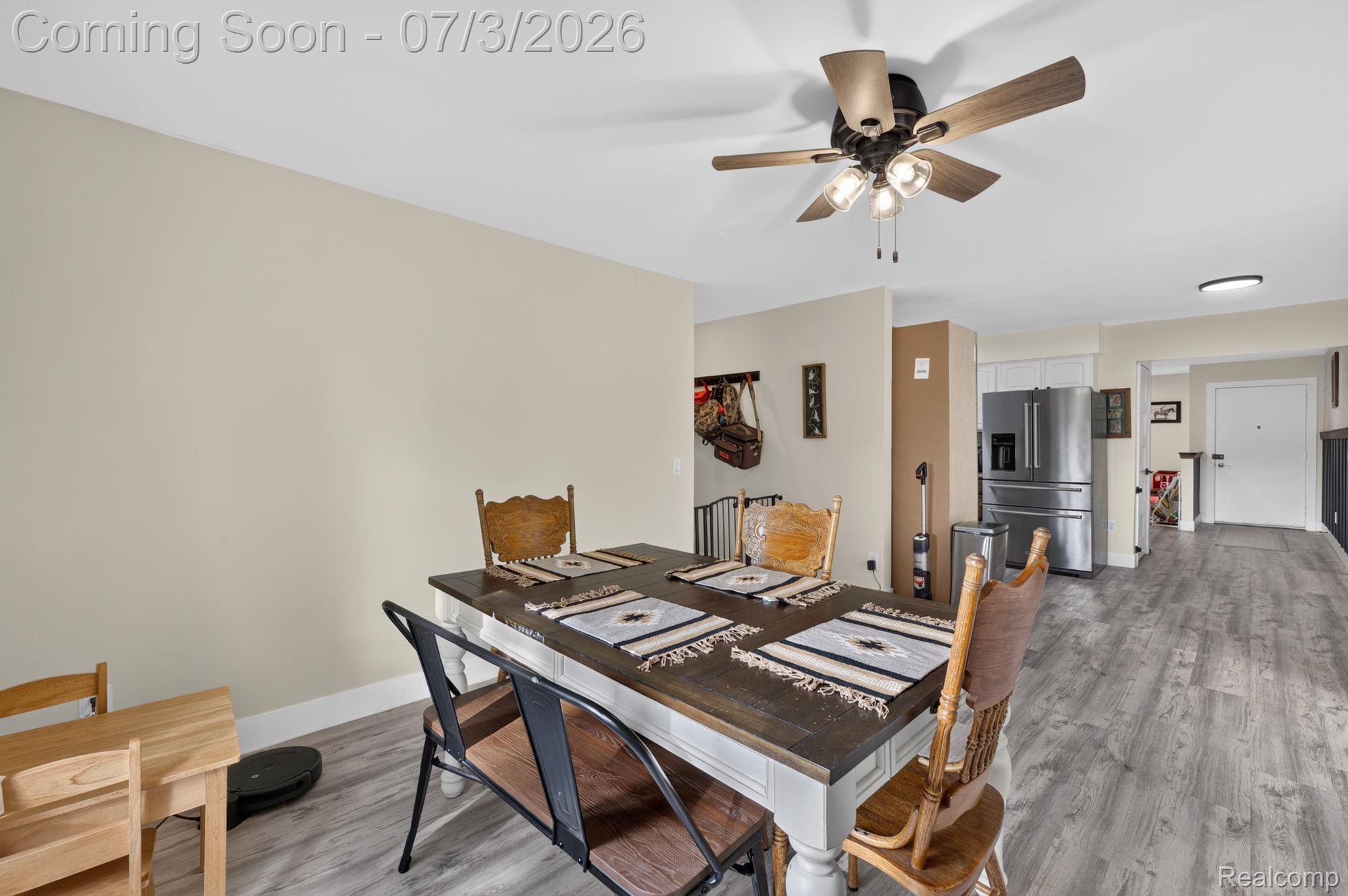 5355 North Seymour Road Flushing, MI 48433 - Photo 16 of 41 Dining area featuring wood-finish flooring, a ceiling fan with integrated lighting, and an open concept layout