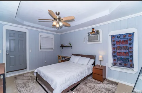 a bedroom with a bed and a chandelier