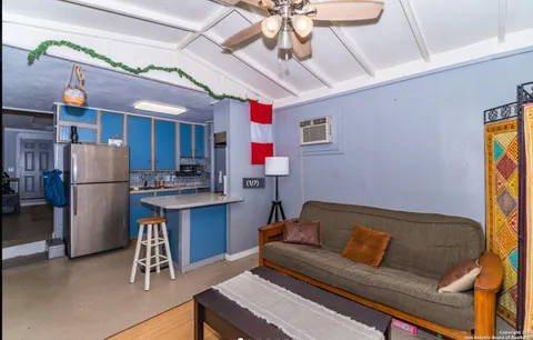 a living room with a couch and a dining table