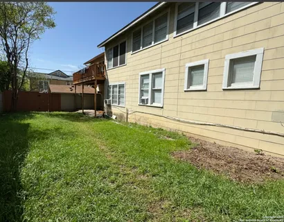 a backyard of a house with lots of green space