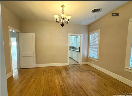 a view of livingroom with kitchen and wooden floor