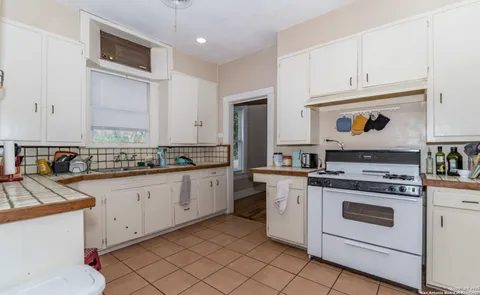 a kitchen with cabinets appliances and a counter
