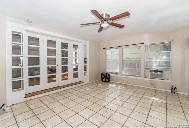 a view of a livingroom with wooden floor and a large window