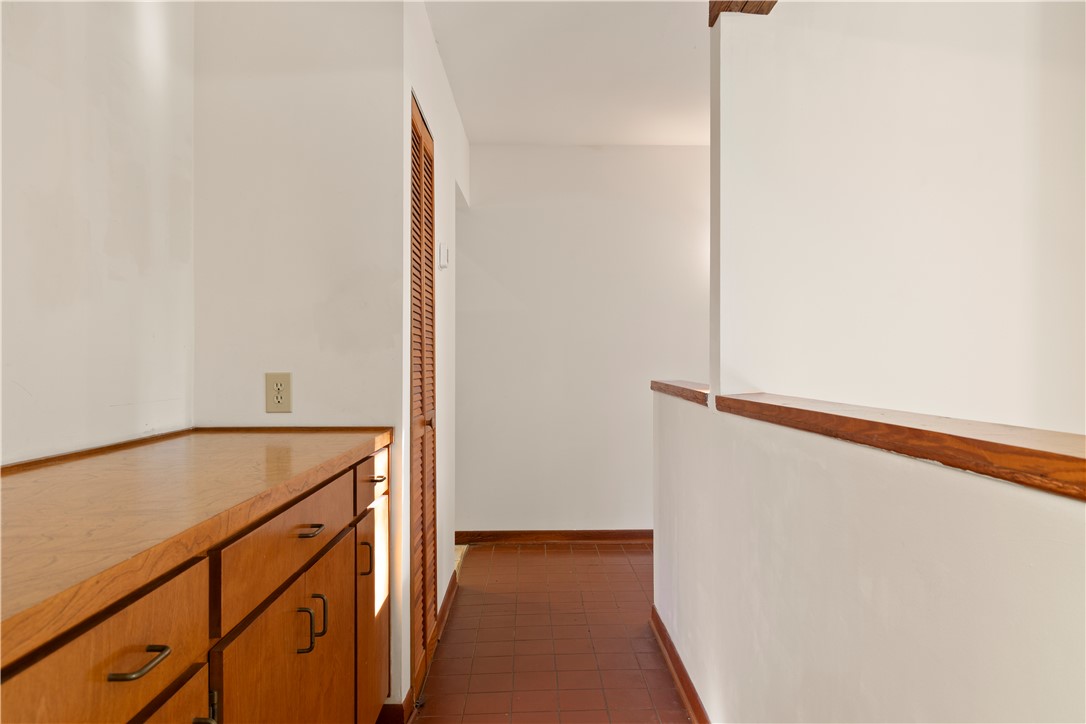 1298 Carradine Road Seneca, SC 29678 - Photo 24 of 43 A well-lit hallway with built-in cabinetry and warm tile flooring offers functional appeal.