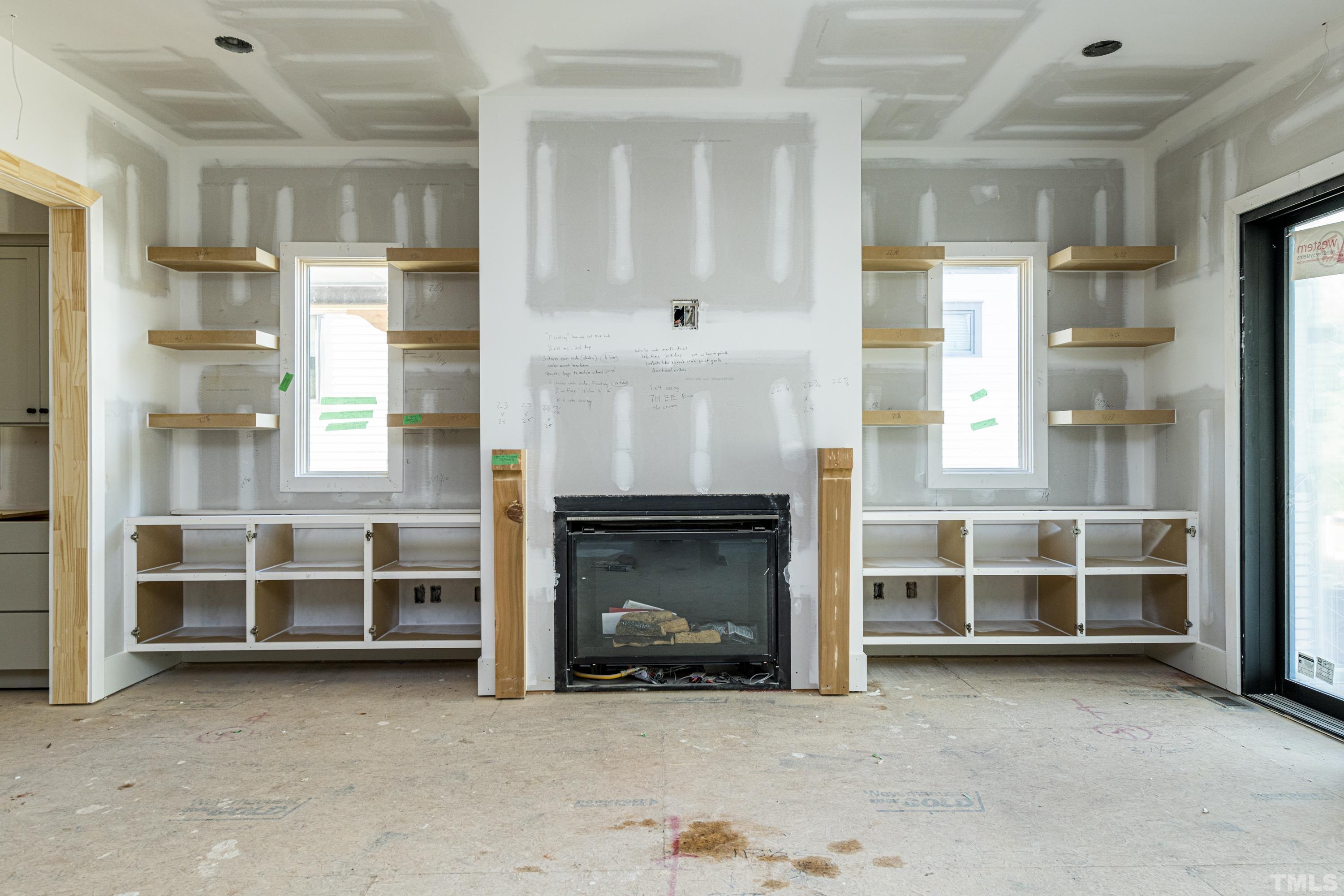 3020 Farrior Road Raleigh, NC 27607 - Photo 12 of 17 an empty room with fireplace cabinet and window