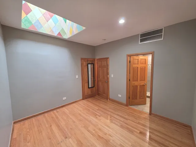 a room with a bed and a painting on the wall