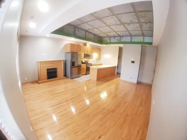 a view of a room with wooden floor