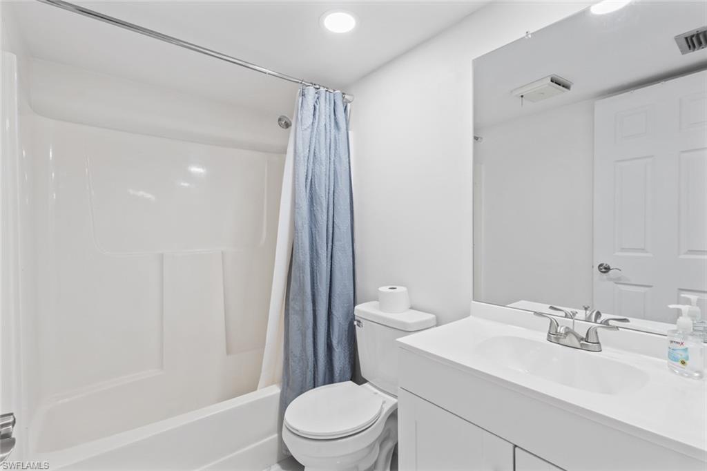452 Bristle Cone Lane, Unit 27 Naples, FL 34113 - Photo 12 of 16 Bathroom with vanity, shower / bath combo with shower curtain, and recessed lighting