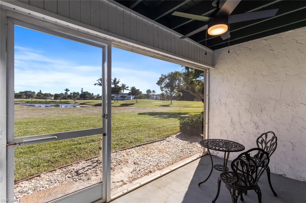 452 Bristle Cone Lane, Unit 27 Naples, FL 34113 - Photo 15 of 16 Sunroom with a water view and a ceiling fan