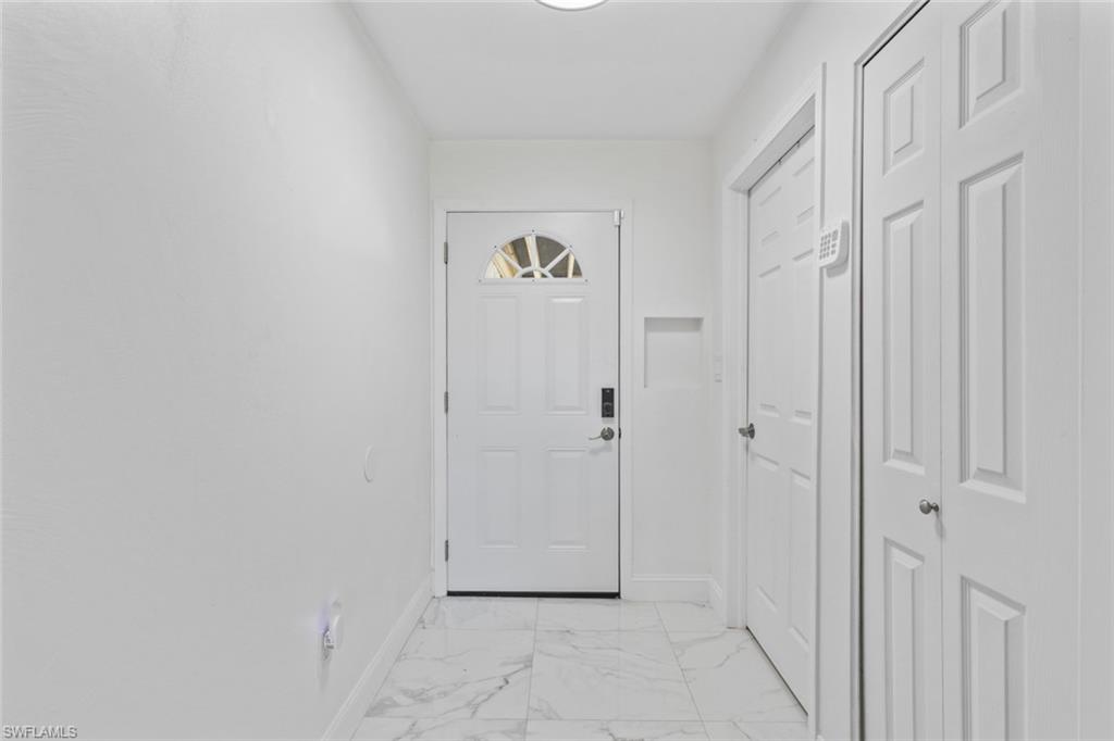 452 Bristle Cone Lane, Unit 27 Naples, FL 34113 - Photo 3 of 16 Entryway featuring marble finish floors and baseboards