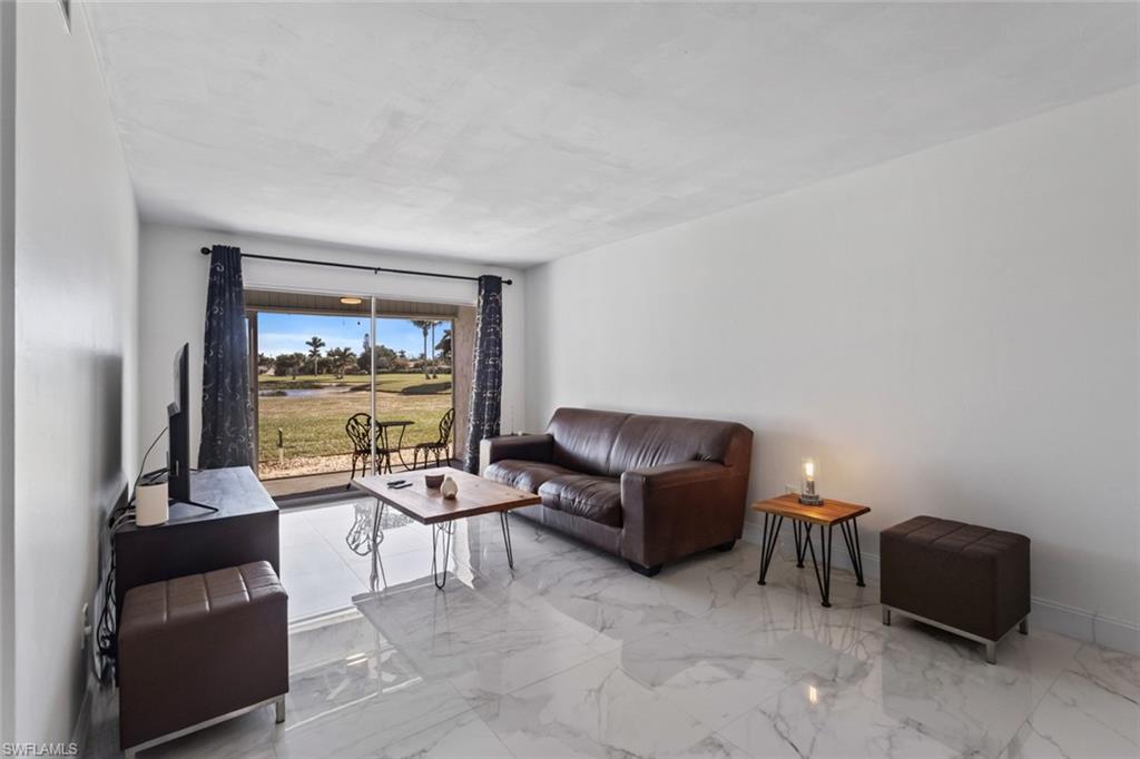 452 Bristle Cone Lane, Unit 27 Naples, FL 34113 - Photo 6 of 16 Living room with marble finish floors