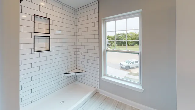 a bathroom with a bathtub and shower